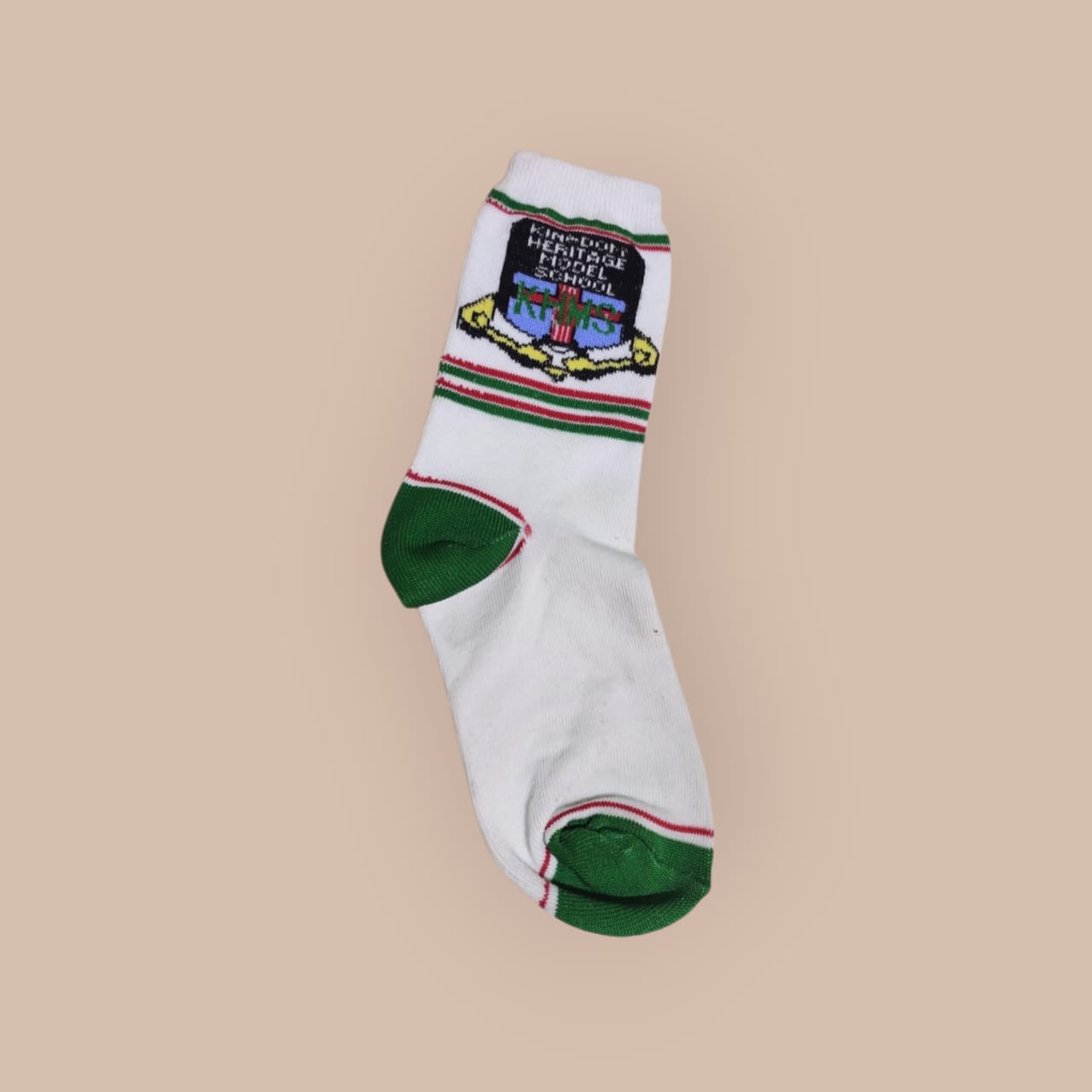 White school sock with green and red stripes, Kingdom Heritage Model School crest and green heel and toe